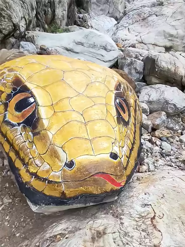 河南一景点石头被彩绘成巨型蛇头 栩栩如生 让人心惊